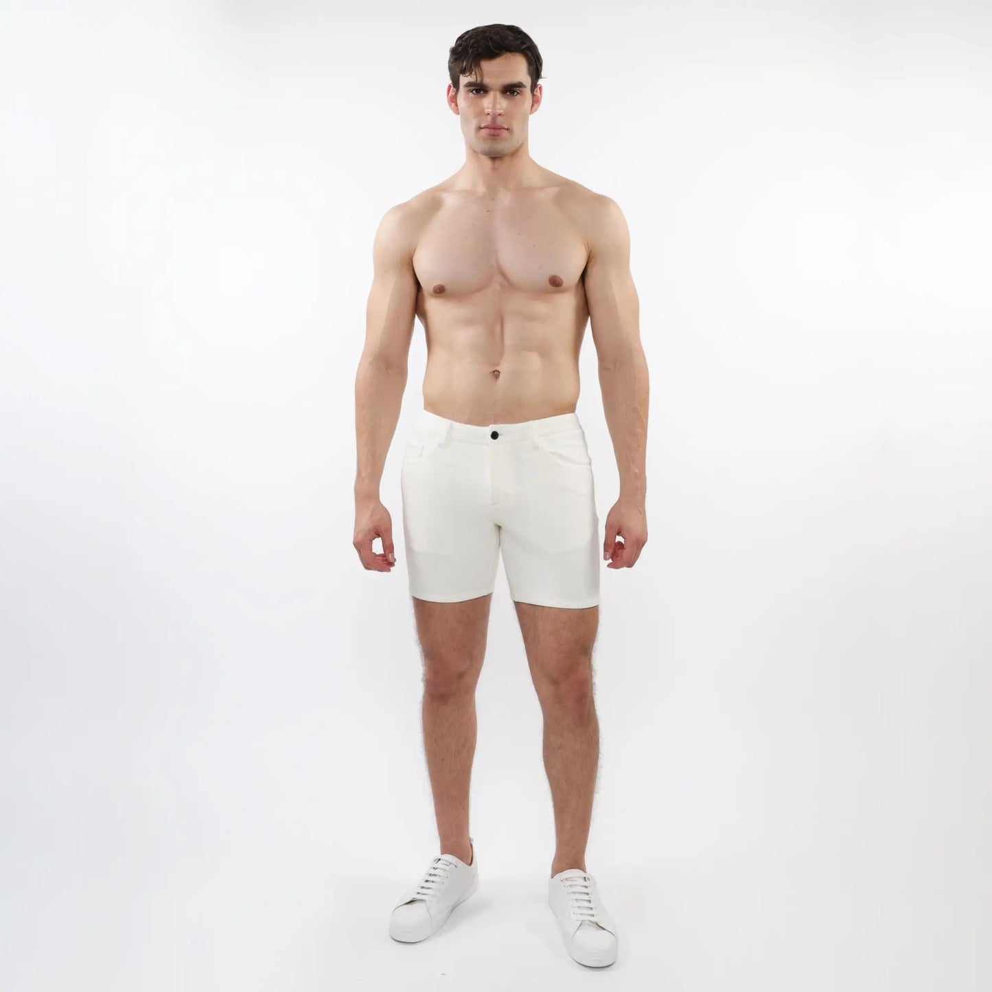 White parquet jacquard stretch knit athletic shorts with sleek minimalist design and single black button waistband