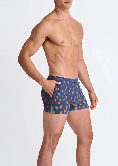 Blue patterned seersucker swim shorts with orange and yellow leaf motifs and mesh lining