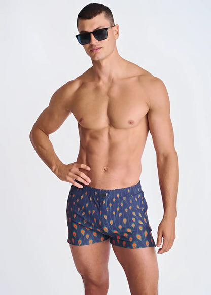 Blue peacock feathers seersucker swim shorts with orange and yellow feather pattern and mesh lining
