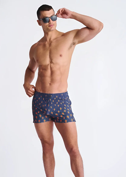 Peacock feathers seersucker blue swim shorts with mesh lining featuring orange and yellow ice cream cone pattern