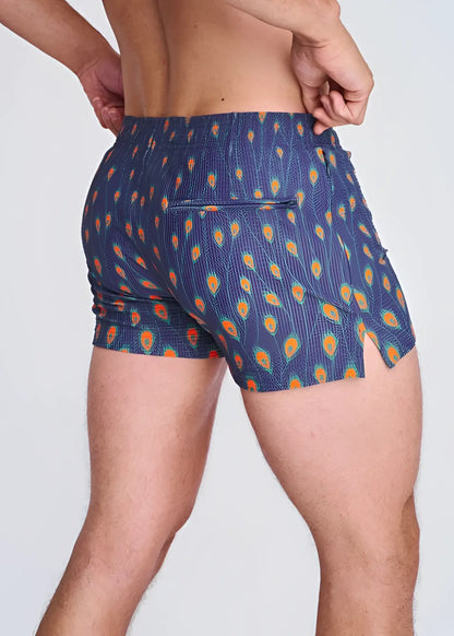 Blue seersucker swim shorts with vibrant orange and teal peacock feather pattern elastic waistband and side slit with mesh lining