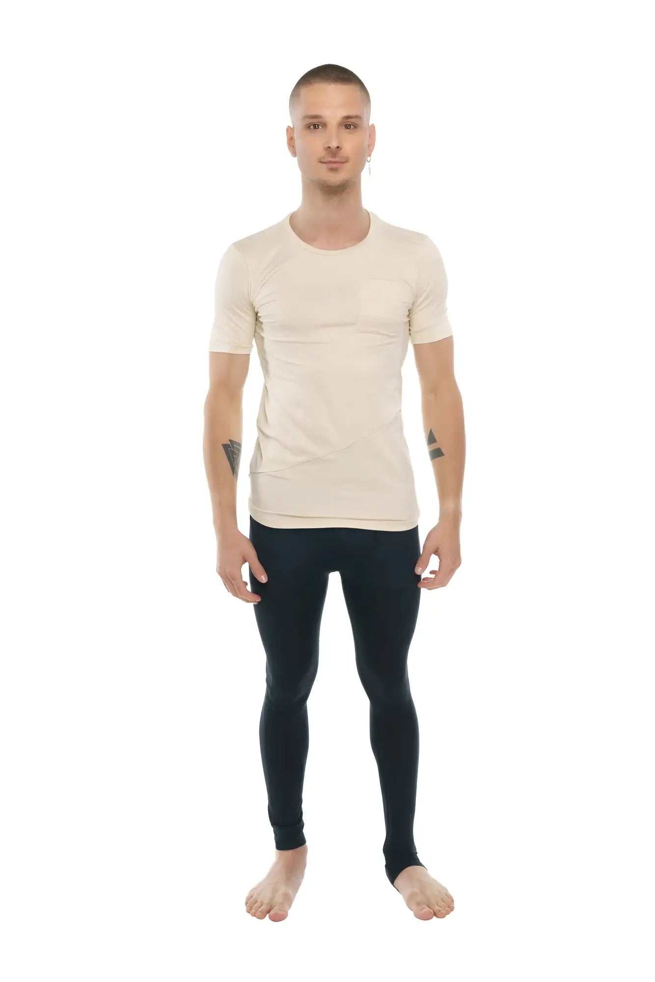 A man wearing a beige perfect pocket crew-neck tee with short sleeves and black fitted leggings