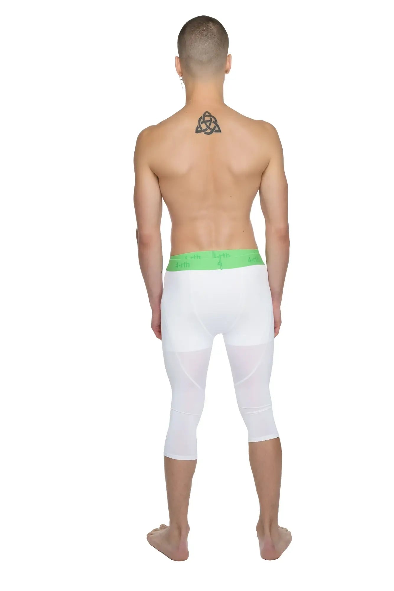 White capri-length performance yoga leggings in arctic white with a bright green elastic waistband for comfort