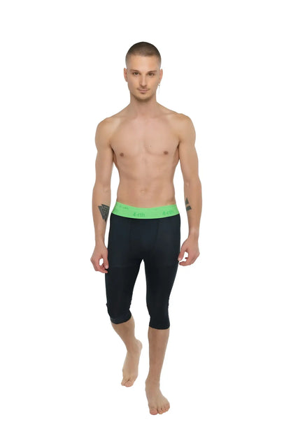 Black capri-length performance yoga leggings with bright green elastic waistband for active wear