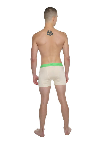 Cream-colored boxer briefs with a bright green elastic waistband designed for performance yoga in sand beige shade