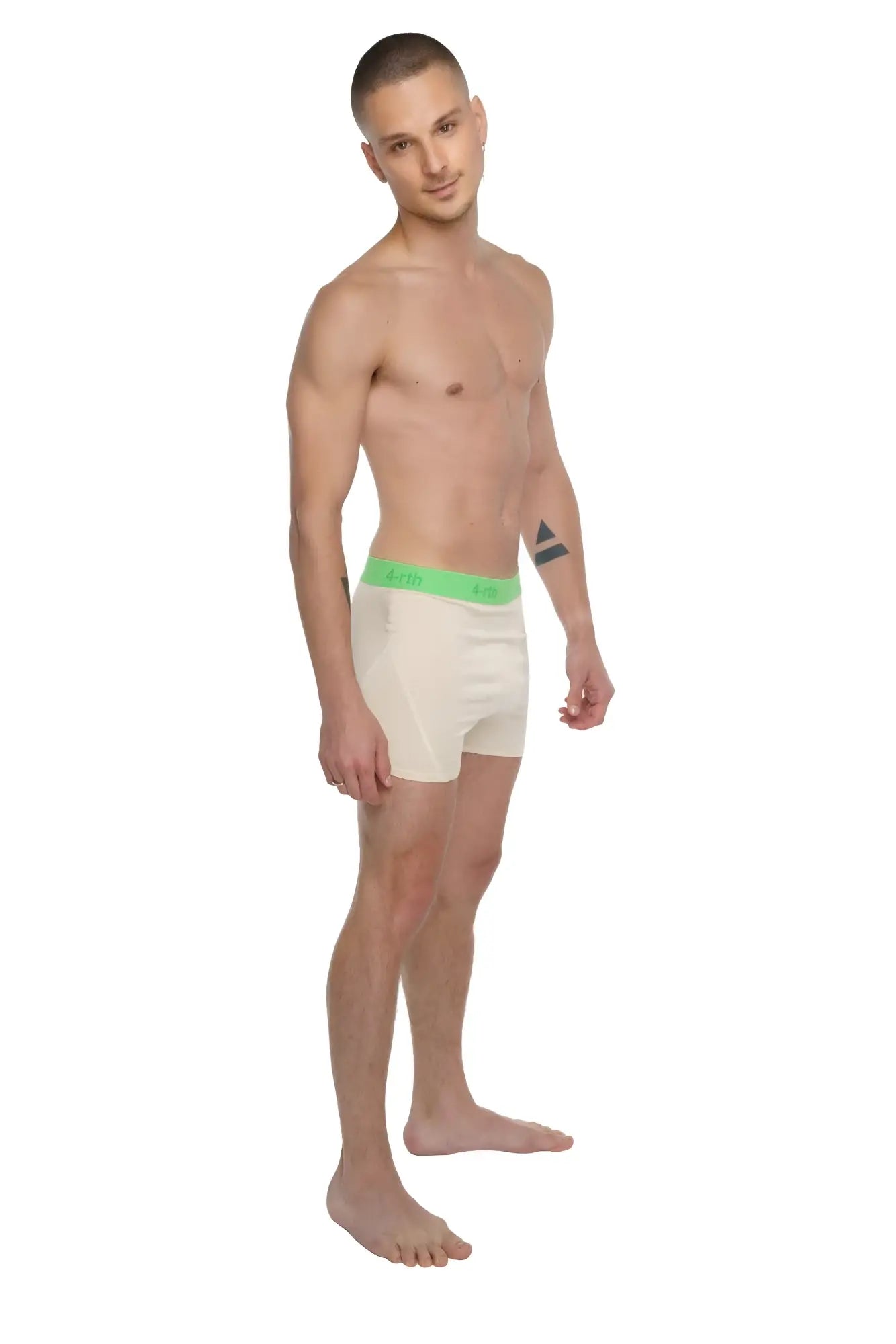 Cream-colored boxer briefs with bright green logo waistband paired with sand beige performance yoga leggings short