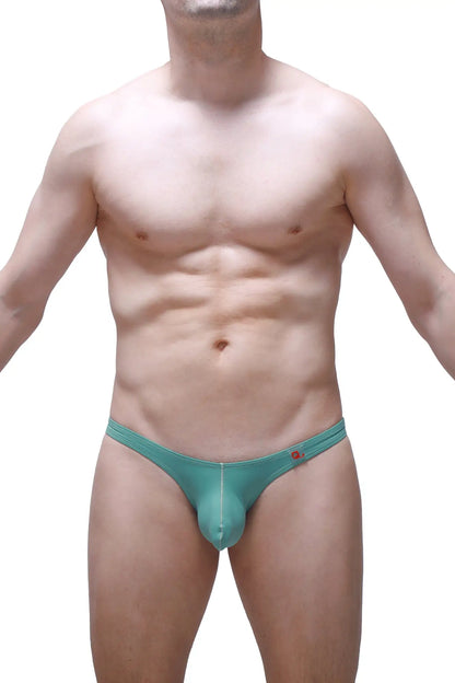 Teal-colored form-fitting men’s thong with subtle seam detail and red logo on waistband petitq bikini dome green
