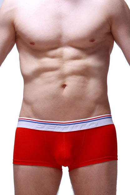 Red petitq boxer push-up men’s briefs with white elastic waistband featuring red blue stripes and petitbag logo