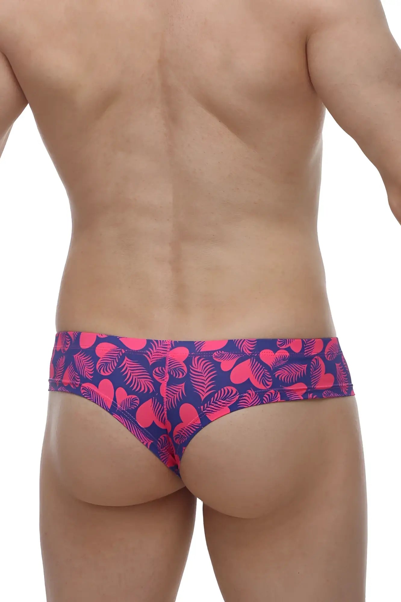Petitq mini boxer tropical hearts swim trunks in vibrant pink and navy blue with a tropical leaf pattern