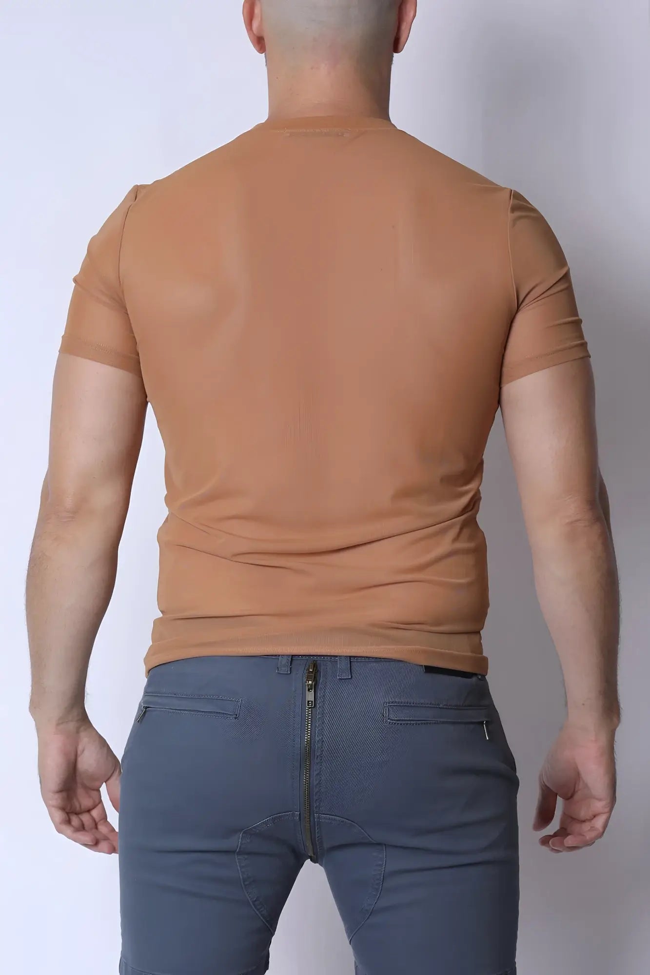 A fitted tan phantom mesh t-shirt with short sleeves and a crew neck made from breathable material