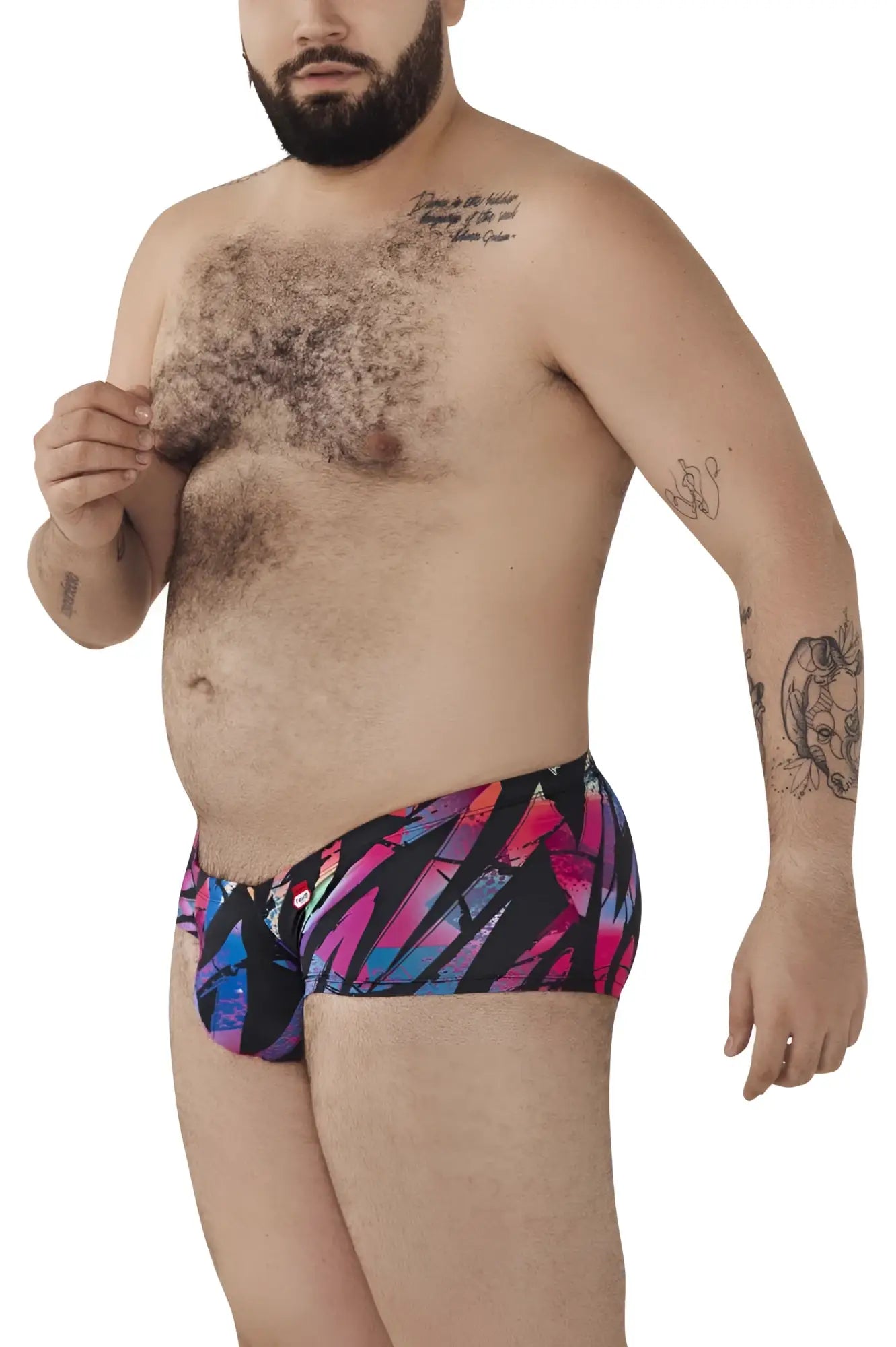 Vibrant geometric-patterned pikante pik 0988x jartum swim trunks in bold pink blue and purple on black background