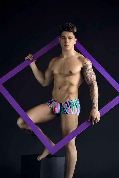 Vibrant pikante pik 1828 abstract trunks in neon pink turquoise and green tropical pattern swim trunks front view