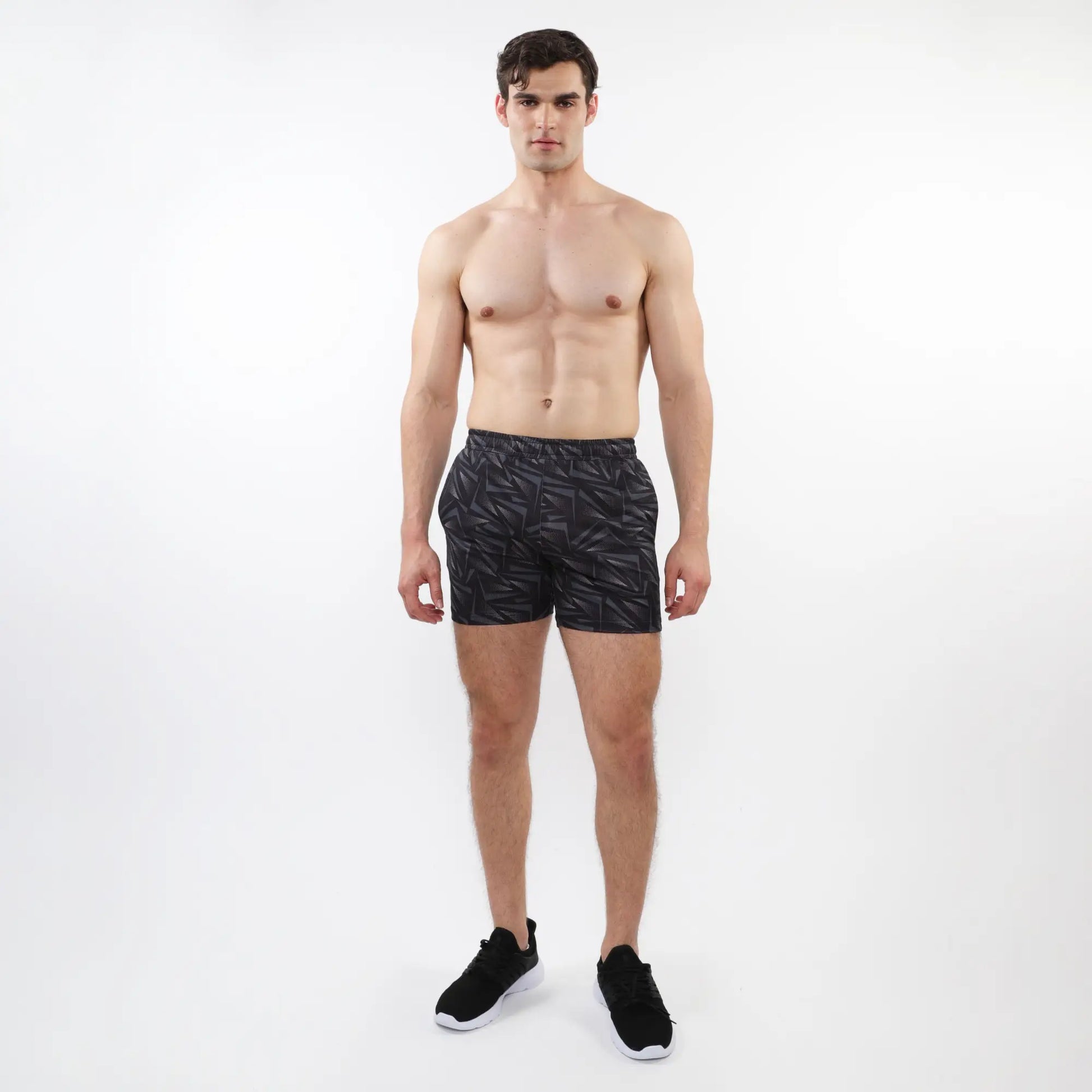 Black printed mesh stretch performance shorts with subtle geometric leaf pattern made from lightweight athletic fabric