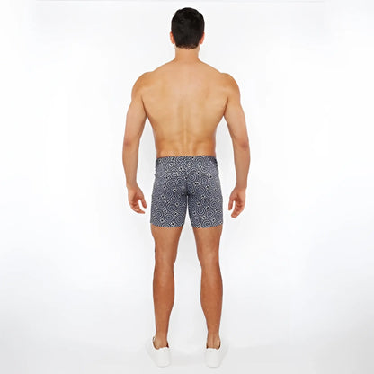 Men’s navy blue printed stretch knit swim trunks with white geometric pattern for comfortable water use