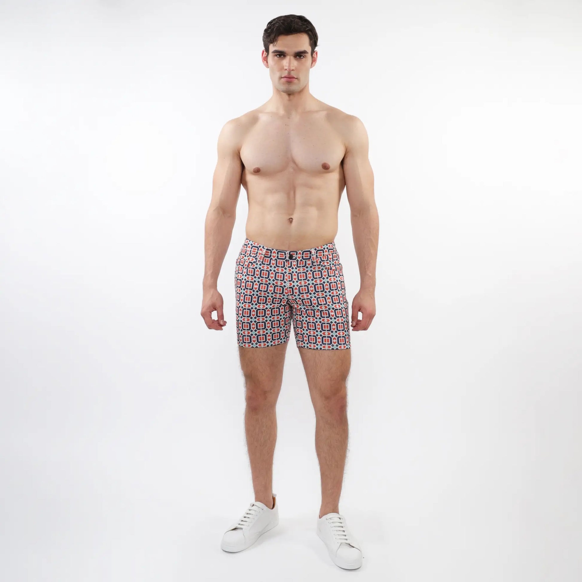 Printed stretch knit short men’s swim trunks with red blue and white geometric patterned design