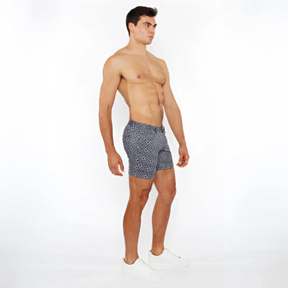Navy blue printed stretch knit short swim trunks with white geometric pattern for comfortable beachwear