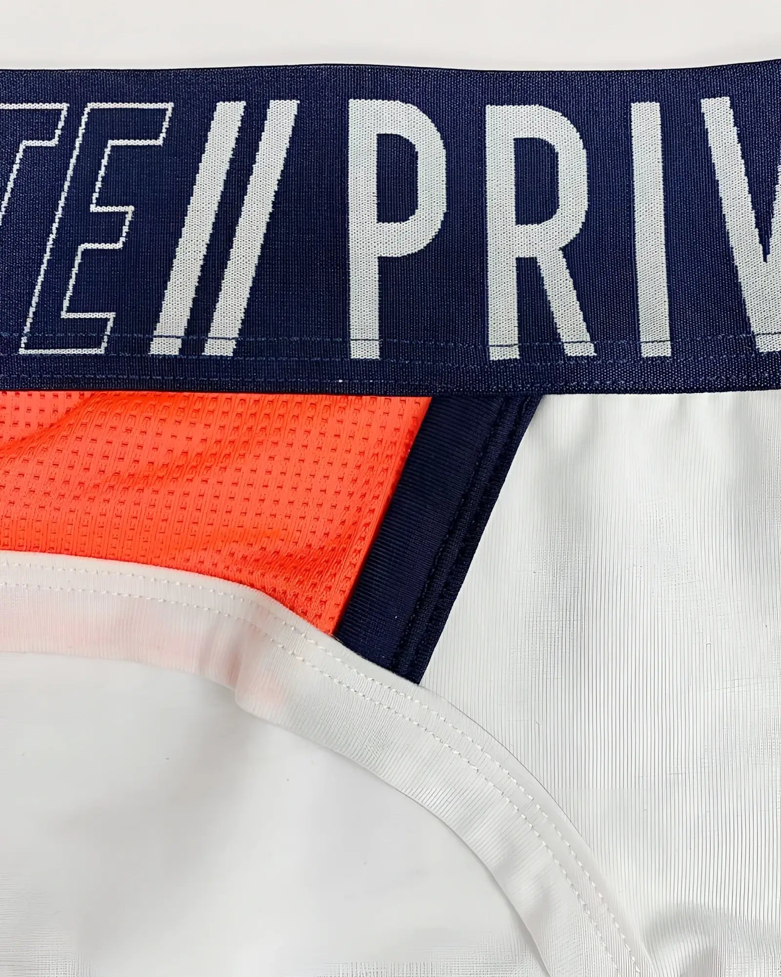Navy blue and white Private Structure BAUT4388 athlete mini briefs with bold orange mesh side panels in white league color