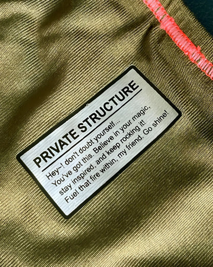 Olive green textured fabric bikini brief with black-bordered silver private structure label and inspirational message