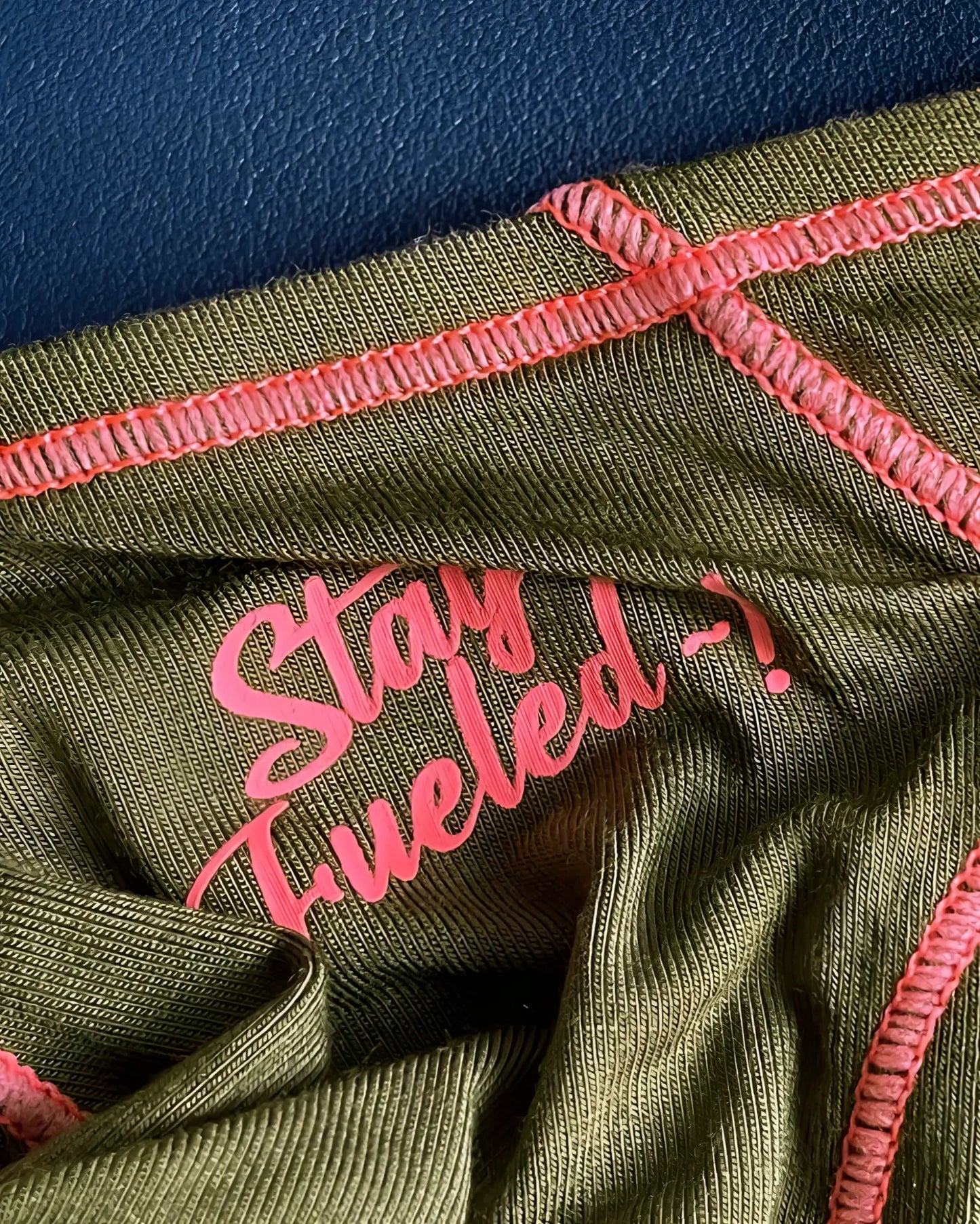 Olive green ribbed fabric prime eutopia bikini brief with pink embroidered text and matching pink stitching
