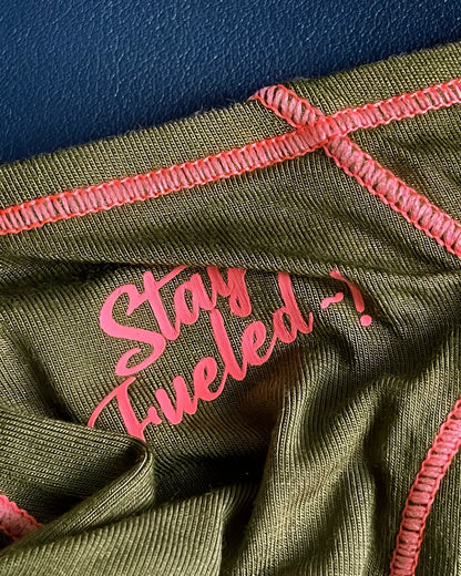 Olive green ribbed fabric prime eutopia bikini brief with pink embroidered text and matching pink stitching