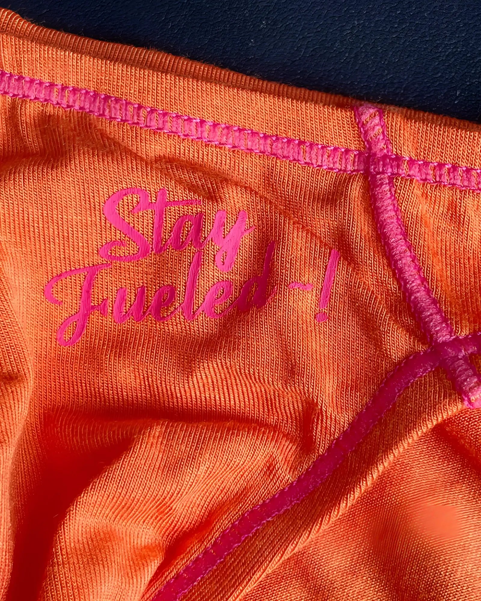 Orange athletic underwear with pink embroidered text and matching stitching private structure prime eutopia bikini brief