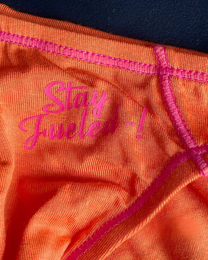 Orange athletic underwear with pink embroidered text and matching stitching private structure prime eutopia bikini brief