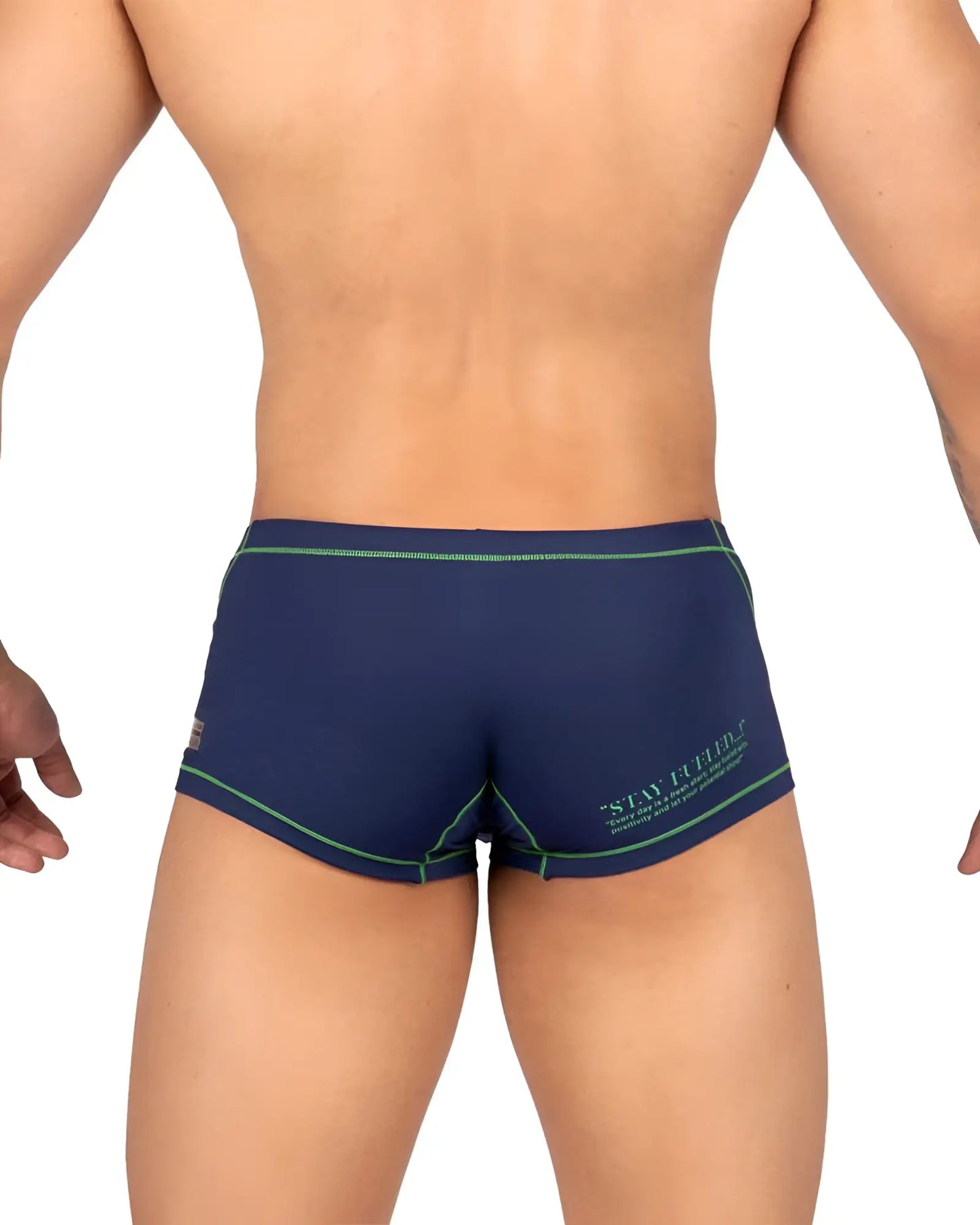 Back view of private structure navy blue swim trunks with green trim and stay firm logo for active beachwear