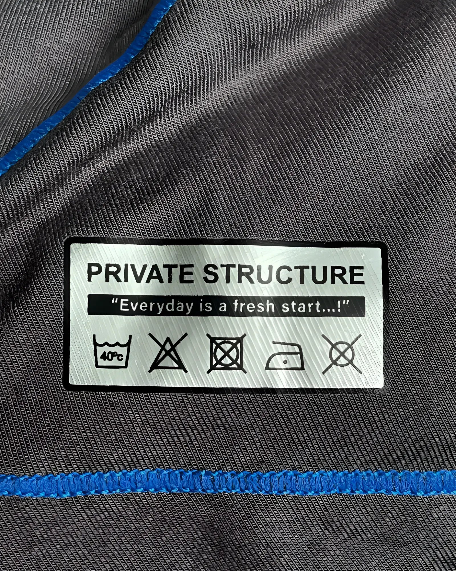 Gray private structure epus4570 prime elysian hipster fabric with blue stitching and white care label on back side