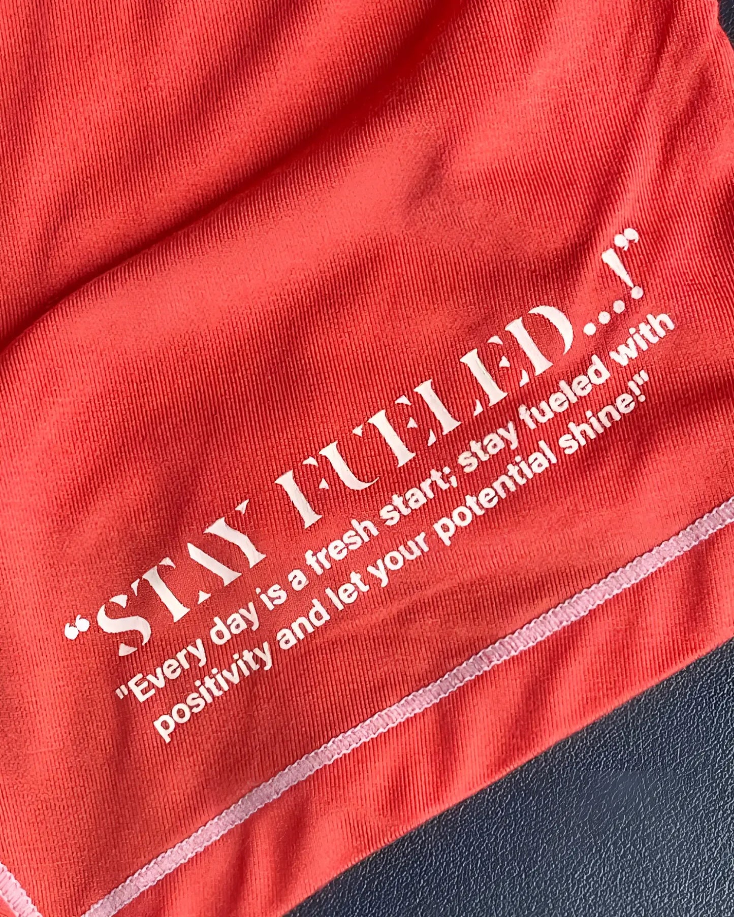 Red cotton t-shirt by private structure with white embroidered stay fueled text and motivational quote in red