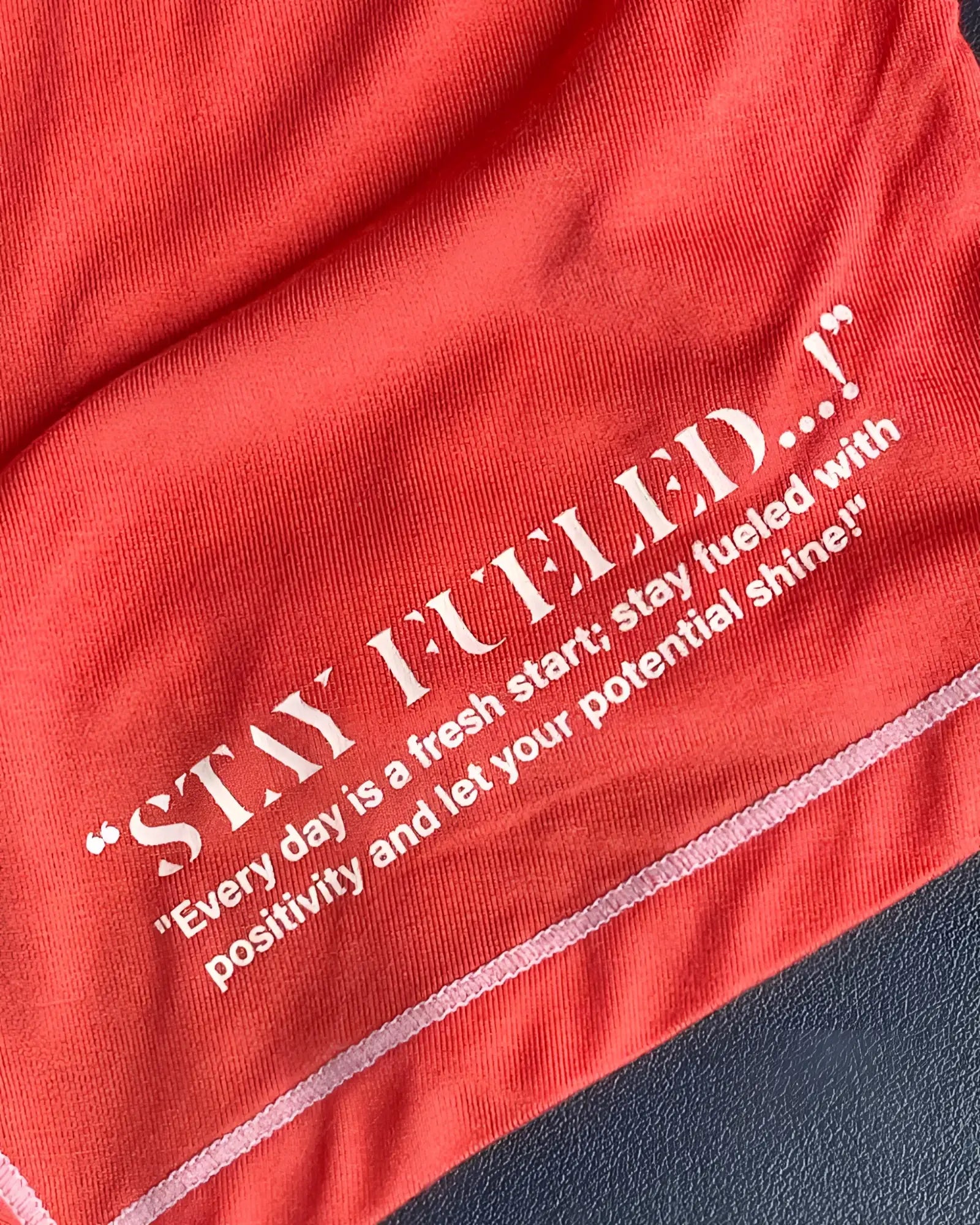 Red cotton t-shirt by private structure with white embroidered stay fueled text and motivational quote in red