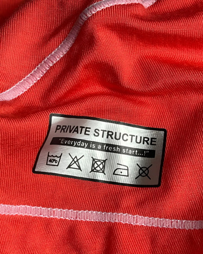 Silver rectangular care label on the back of private structure epus4570 prime elysian hipster in red with laundry instructions