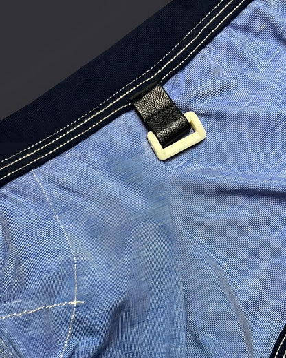 Private structure lcut4359 barn boy low rise trunk in denim with black leather strap and cream plastic buckle on blue fabric