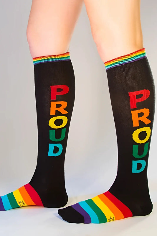 Black knee high socks with proud in rainbow letters and matching rainbow striped cuff and toe for pride wear