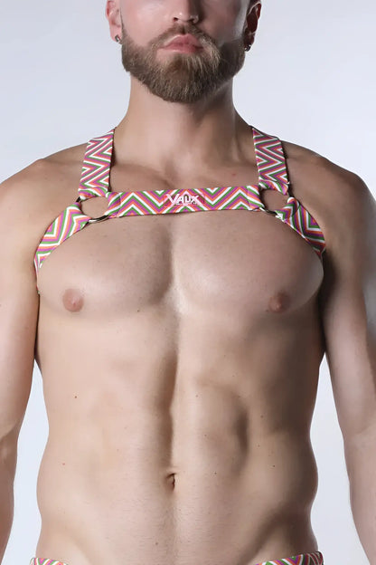 A man wearing a pulse elastic harness with vibrant geometric zigzag stripes in pink green and white visible from the front