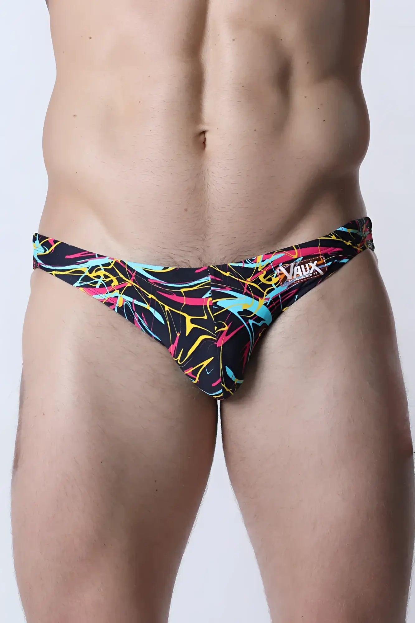 Black pulse swim brief with vibrant neon pink yellow and cyan abstract line patterns for swimming and beachwear