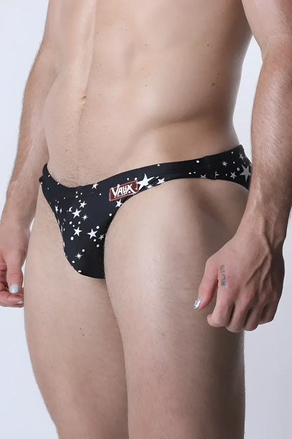 Pulse swim brief black swim trunks with white star patterns and red vaux logo on waistband front view