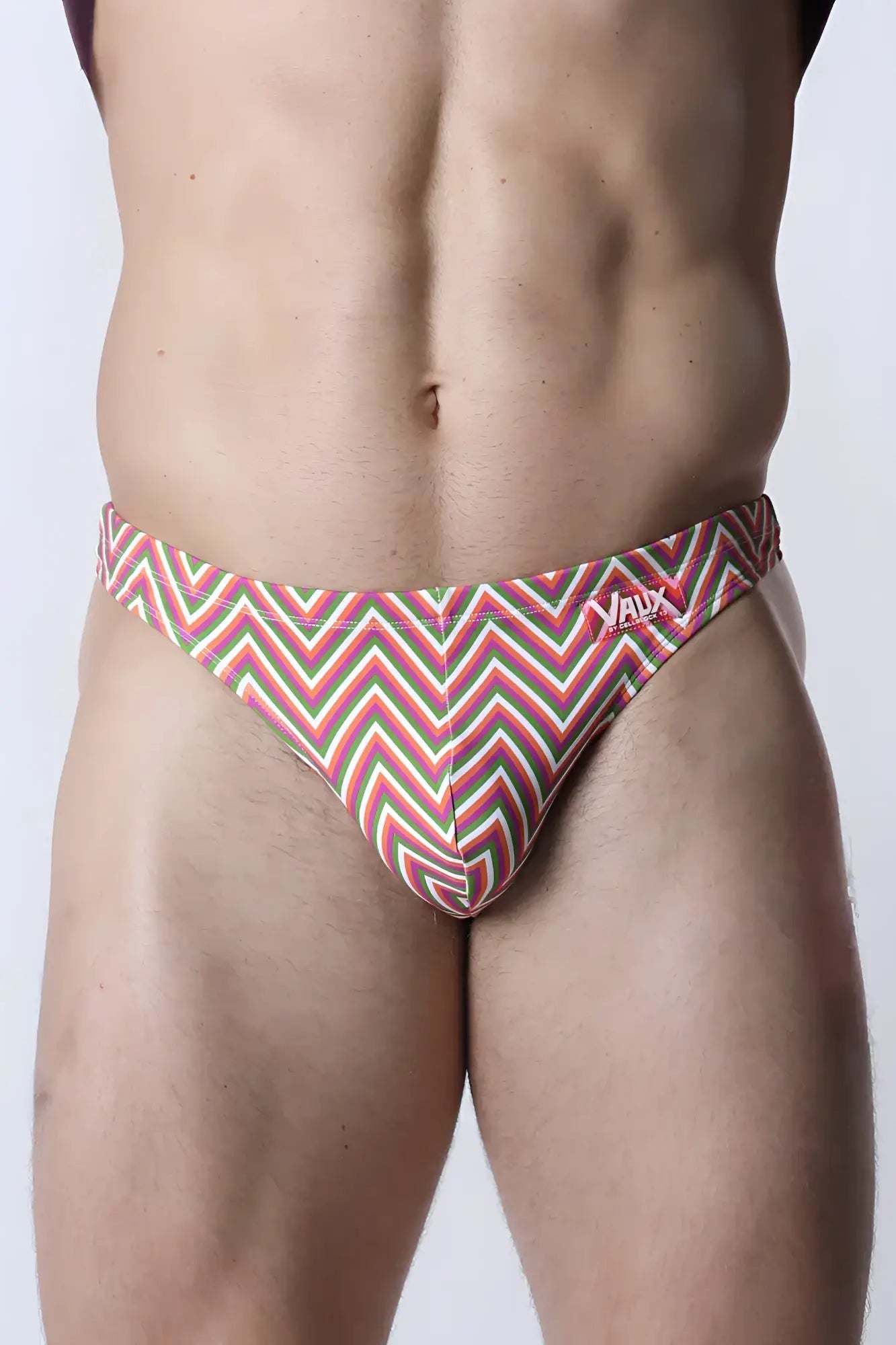 Vaux pulse swim thong men’s swim trunks with bold red green and white zigzag pattern for beach and pool use