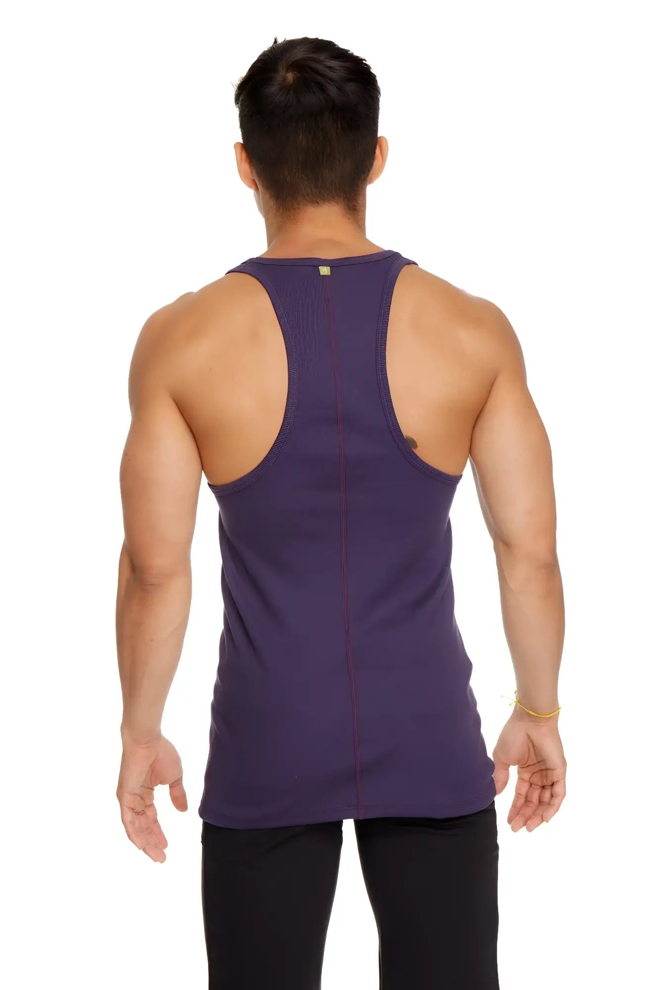 A deep purple racer-back yoga tank with form-fitting design and subtle vertical seam detailing shown from the back