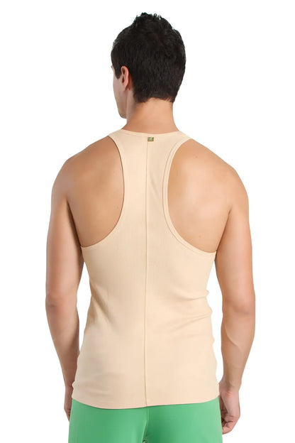 Beige racer-back yoga tank top with central seam and subtle brand tag at neckline for active wear