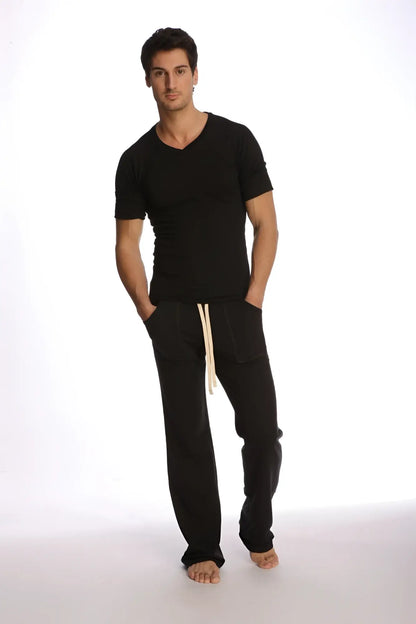 Black cotton joggers with cream-colored drawstrings paired with raglan virtual crew neck in black front view