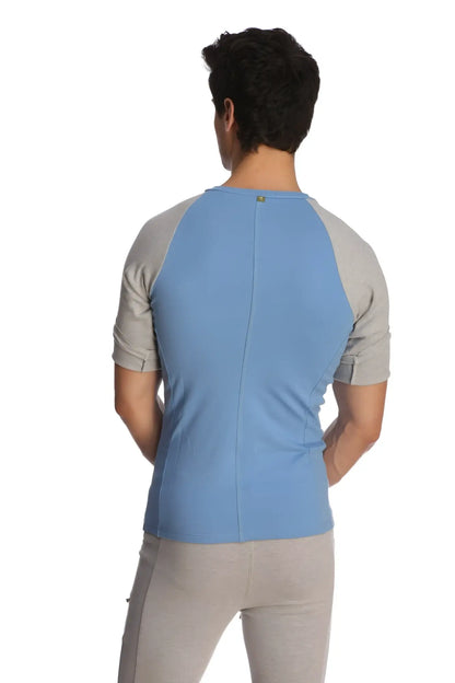 Back view of light blue and gray raglan virtual crew neck shirt with subtle vertical seam for athletic wear