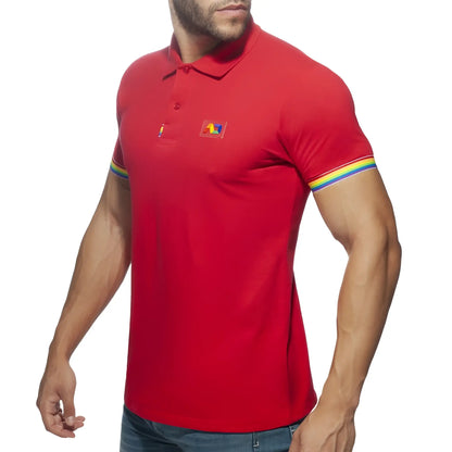 Red men’s cotton polo shirt with rainbow trim on sleeves and a small colorful logo patch on the chest