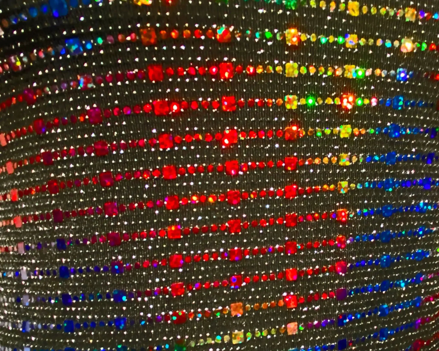 Rainbow sequin tank featuring shimmering black fabric with vibrant rainbow rhinestones in diagonal rows