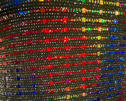 Rainbow sequin tank featuring shimmering black fabric with vibrant rainbow rhinestones in diagonal rows