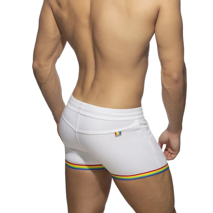 White cotton athletic shorts with rainbow stripe trim and small rainbow flag logo on waistband rainbow tape cotton short