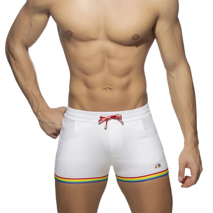 White cotton swim trunks with rainbow tape trim and red drawstring designed for casual beachwear