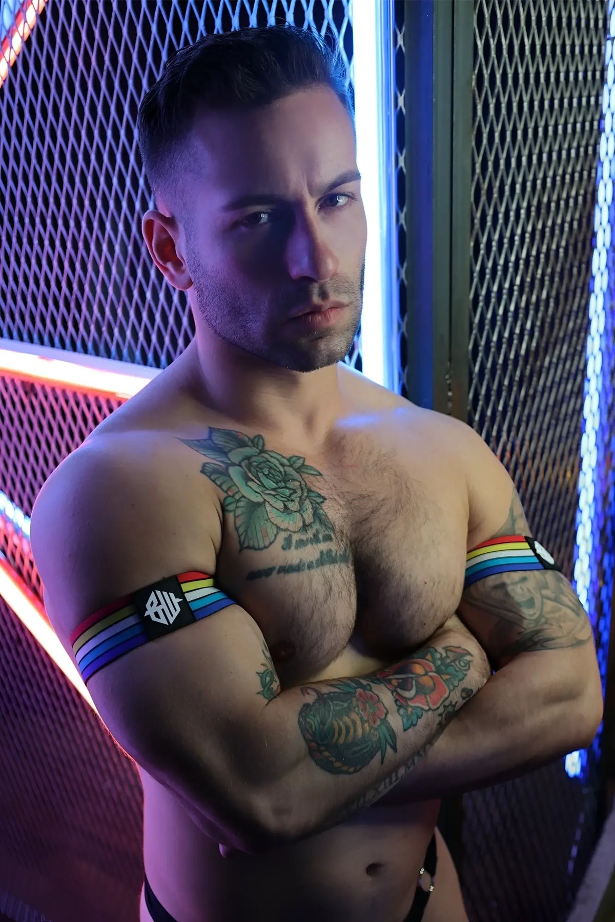 Retro remix armband featuring a rainbow-striped fabric design with a black logo patch on the front side