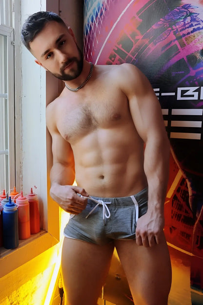 Gray retro remix athletic shorts with white drawstring and side stripes made of breathable fabric
