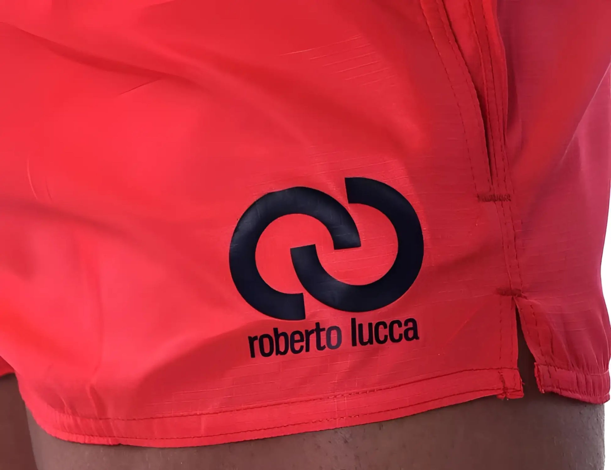 Bright red roberto lucca solid shorts with bold black logo and interlocking circle design swimwear size l