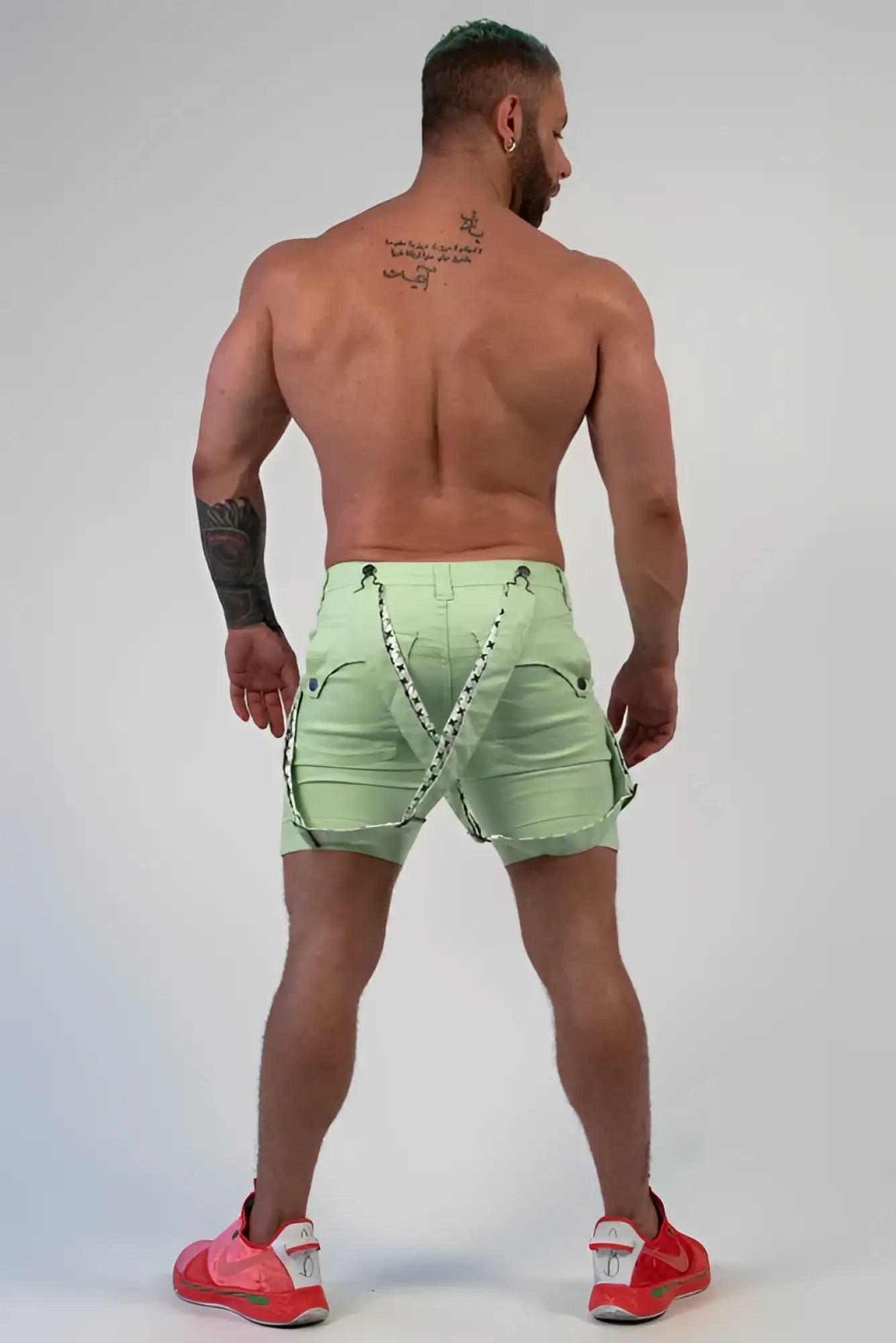 Romey shorts light green cargo shorts with black and white patterned straps shown from the back side